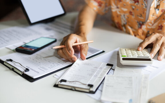close-up shot, casual man start new business at home checking receipt calculate expenses. working at home doing online business, E-commercr concept