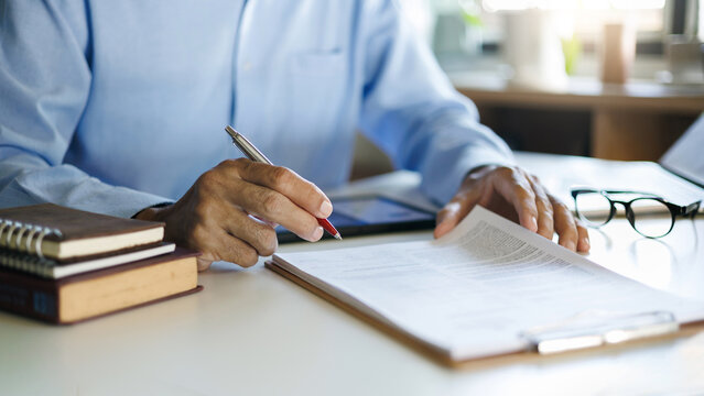 close up shot, asian businessman checking business ducument before signing agreement contract making a deal