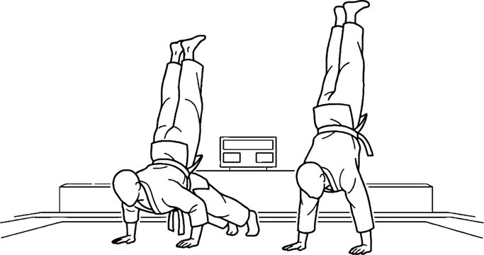 Two judo athletes practicing handstands on a mat.