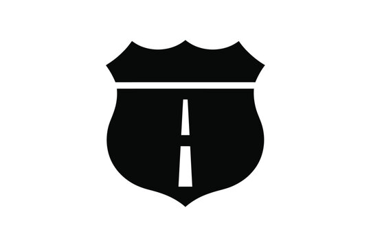 Minimalist black highway shield vector icon representing a road trip route sign with a classic interstate badge silhouette and central asphalt lane division marker on a plain white background