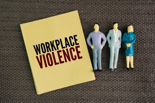 Miniature people and paper with the word Workplace violence. any act or threat of physical violence, harassment, intimidation, or threatening behavior occurring at the work site.