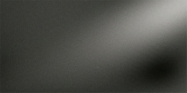 Spotlight beam illuminating a textured, monochromatic surface, creating a dramatic contrast between light and shadow.