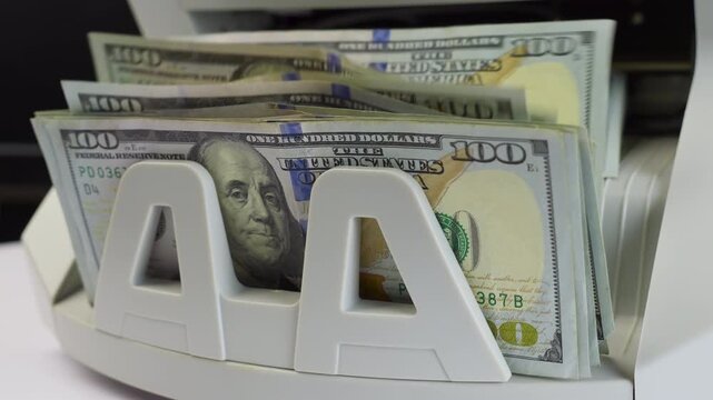 Electronic Money Counting Machine Processing a Stack of US 100 Dollar Bills with Benjamin Franklin Portrait, jib shot, slow motion
