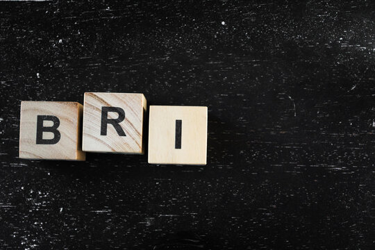 Wooden block with letter in black background
