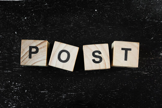 Wooden block with letter in black background