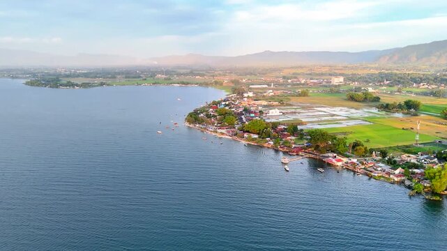 Cinematic aerial view of afternoon atmosphere at Pasir Putih Beach, Toba Lake, Balige