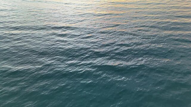 Cinematic aerial view of sunset at Pasir Putih Beach, Lake Toba, Balige