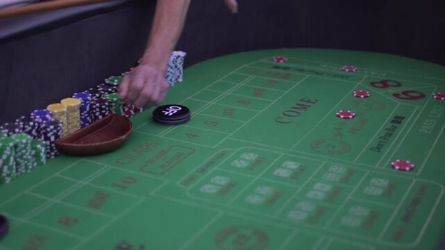 Slow motion craps dice roll on green felt table with chips and markers