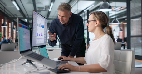 Naklejka premium Two Professionals Examining Digital Risk Dashboard