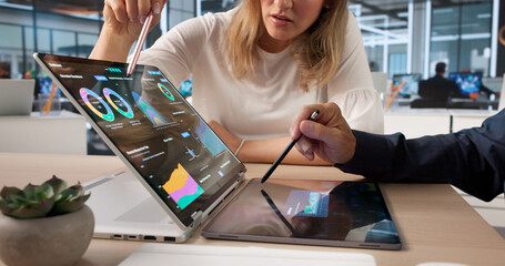 Two Data Analysts Using Laptop And Tablet