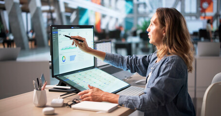Mature Business Manager Using Touchscreen Computer