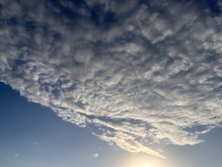 Obraz premium Peaceful and inspiring blue sky with beautiful textured clouds. Minimalist nature background representing freedom, tranquility, hope, and a bright positive future.