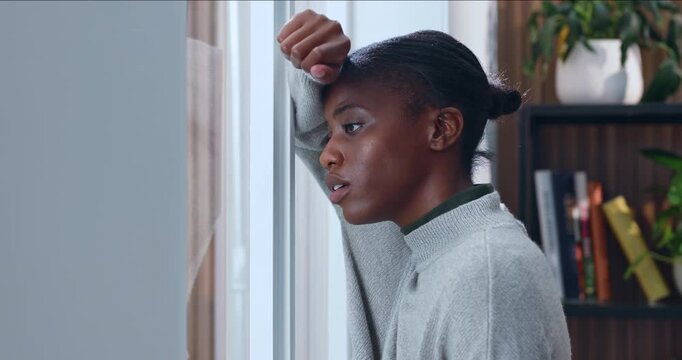 Black woman, anxiety and window in home for fear, overthinking or loss with pressure or regret. Trauma, overwhelmed or person with depression in living room with stress, mental health or self doubt