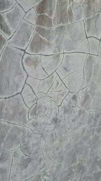 Close Up of Cracked Grey Concrete Wall Texture with Weathered Grunge Look
