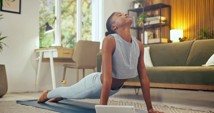 Cobra, fitness and black woman in home living room with tablet for online tutorial, exercise and blog. African person, tech and lounge for yoga stretch, wellness and health for self care in house
