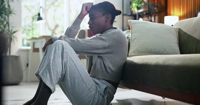 Black woman, stress and overthinking in home for mistake, fear or loss with pressure or regret. Trauma, panic or female person with depression in living room with anxiety, mental health or self doubt