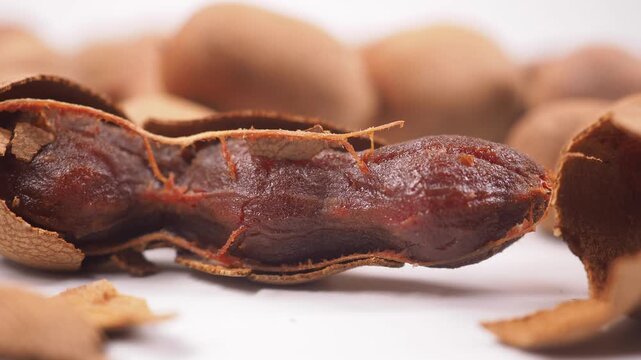 Tamarind fruit is split open to reveal its sweet pulp