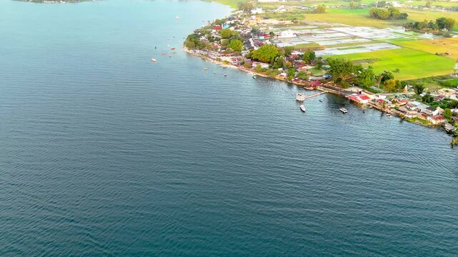 Cinematic aerial view of afternoon atmosphere at Pasir Putih Beach, Balige