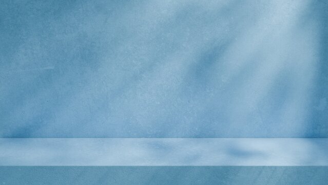 Modern blue wall concrete studio background with soft grey shadows and elegant light, for product mockups and presentation