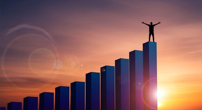 Silhouette standing on top of a bar graph at sunset
Triumphant person on the highest bar of a chart
Business success concept with bars and sunset sky
Person with arms outstretched atop a rising bar gr