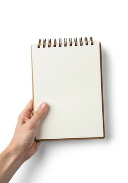 Hand holding a blank spiral notebook