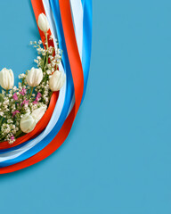 Netherlands Liberation Day Red White Blue Ribbon With Flowers and Blue Copy Space