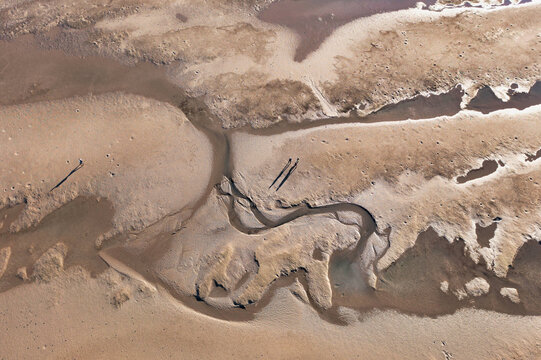 People walking on the mud flats on lily's beach near Tannum sands