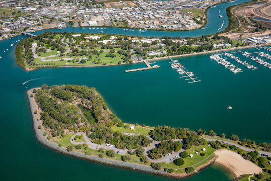 Aerial view of two islands with marina and urban coastline at sunset