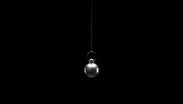 Minimalist cinematic studio shot of a single shiny silver pendulum suspended by a thin wire against a solid black background