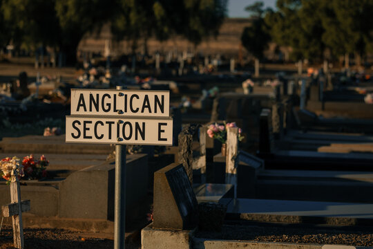 Anglican Section E sign in a quiet cemetery at golden hour