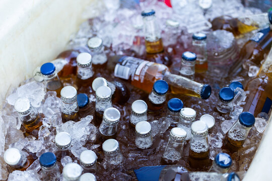 alcohol drinks in an ice filled esky at party