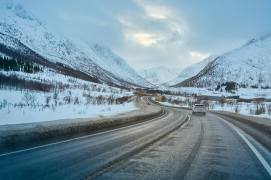 Epic Winter Lofoten Road Trip: Driving a White SUV Through Snow-Covered Mountain Valley in Arctic Norway, POV Scenic Journey.