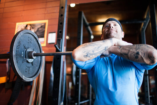 Strong man preparing for front squats at the gym