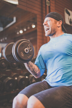Man yelling while doing a heavy bicep curl