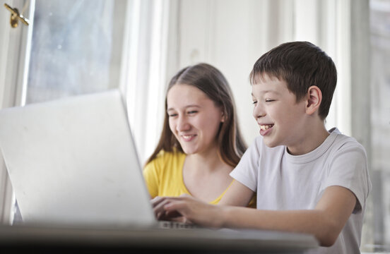 Happy children using a laptop computer together