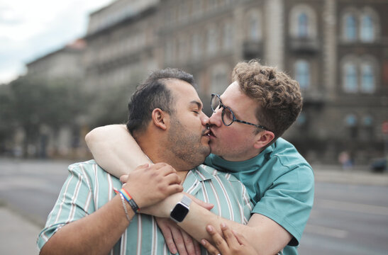 Gay couple sharing an intimate kiss outdoors