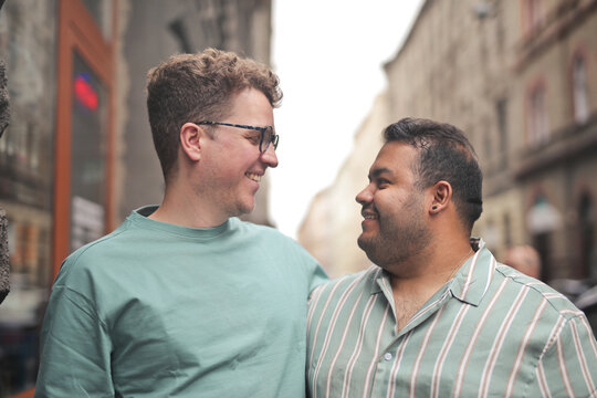 A smiling gay couple enjoying a moment together outdoors