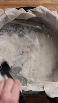 Brushing Phyllo Dough With Olive Oil Top View Vertical