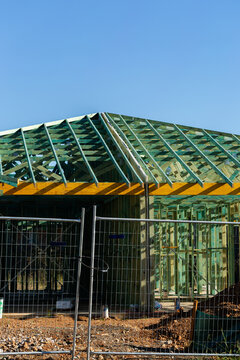 wooden frame structure of house under construction during housing crisis