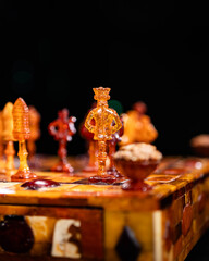Close-up on the old-time amber-made chessboard with the king and pawns figure © Matt A. Hawk
