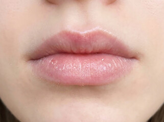 Obraz premium Extreme close up of pink lips with visible texture and shine mouth