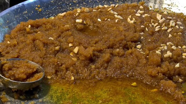 Moong dal halwa - Traditional Indian dessert made from yellow moong dal, ghee, sugar, and milk or water and is garnished with dry fruits.