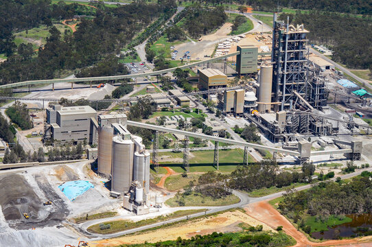 Industrial cement plant with silos and processing tower