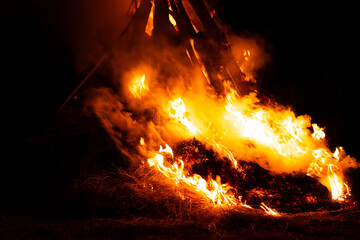 Massive bonfire burning hay and wood with smoke at night © Ionut Gaspar