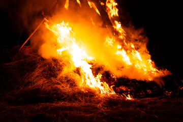 Large bonfire burning dry hay and straw at night outdoors © Ionut Gaspar
