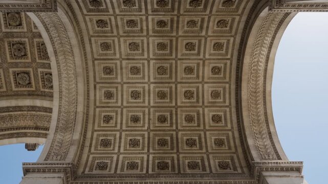 Arc de Triomphe coffered ceiling vault and engraved stone wall names in Paris France. Historic military monument features sculpted relief panels for architectural education and history tourism.
