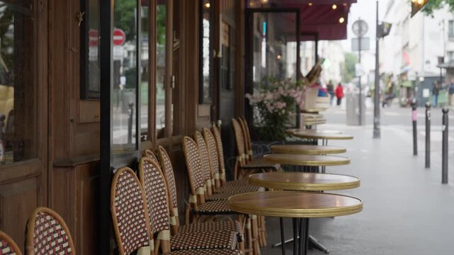 Traditional Parisian cafe terrace on a street sidewalk in France. Classic French bistro outdoor seating represents European restaurant hospitality industry, local culture and tourism travel lifestyle.