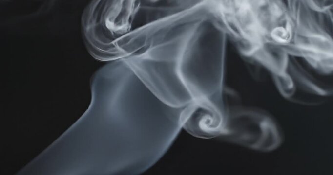 Smoke swirling in the darkness slowly.