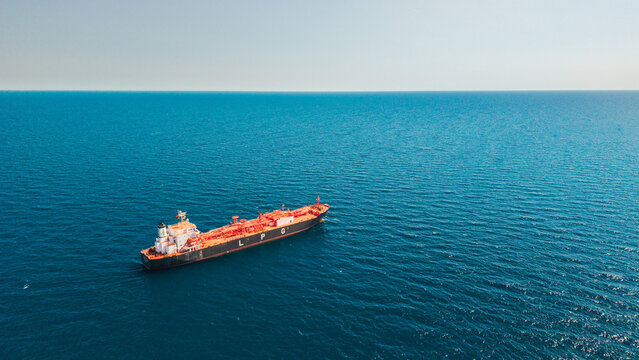 Aerial view of LPG tanker vessel sailing across open Mediterranean Sea with vast blue water and copy space