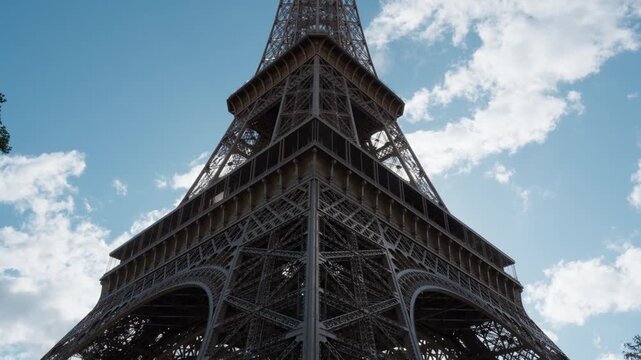 Eiffel Tower steel lattice construction stands in Paris France as historical heritage landmark monument for European travel tourism destination vacation trip industry exploration background.